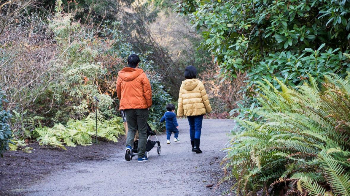 A family walking in fall or winter at Bellevue Botanical Garden