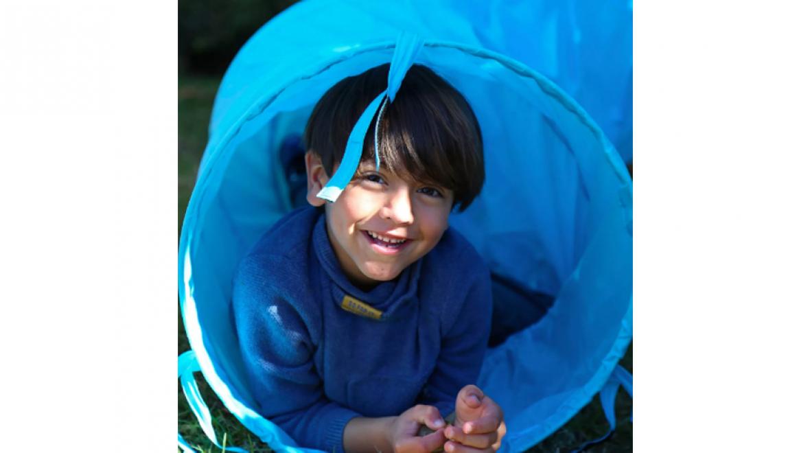 boy in a blue tunnel