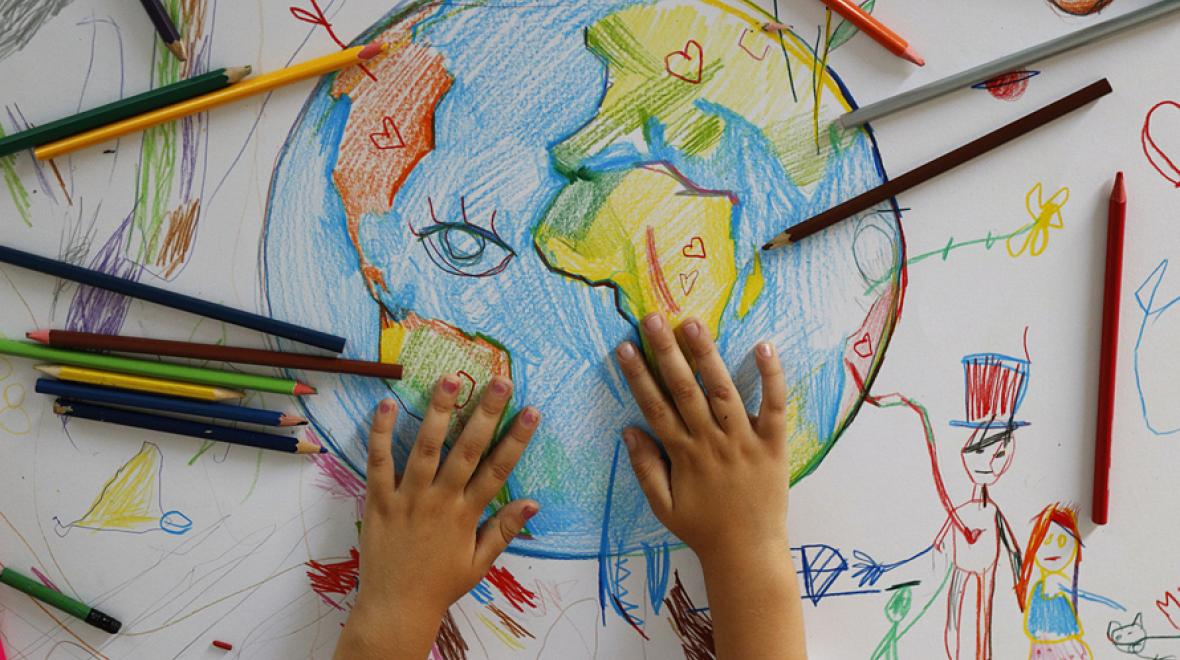 hand drawn globe with colored pencils and a kid's hands