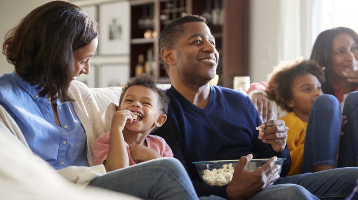 family watching a movie together with popcorn