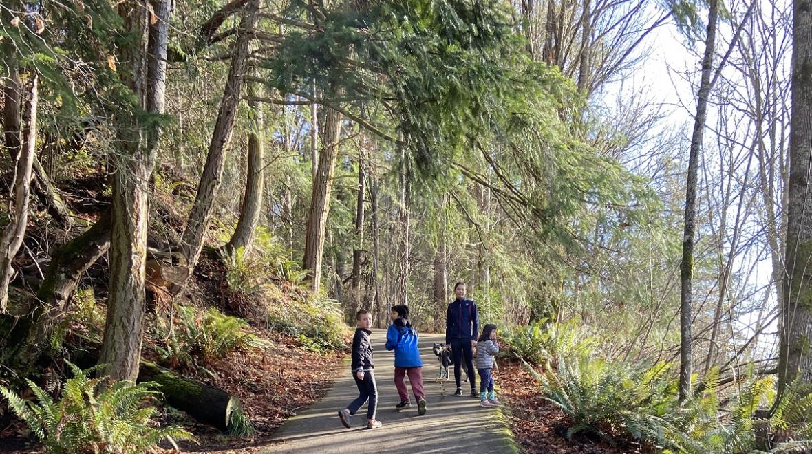 Group of kids hiking along a paved trail near Fort Ward on Bainbridge Island best hikes with kids
