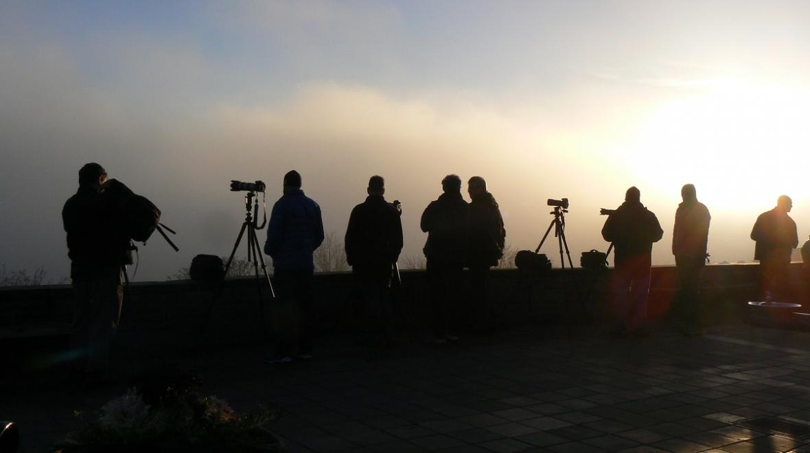 A row of photographers wait to get the best shot from Seattle's Kerry Park overlooking downtown best places to appreciate stormy weather with kids around Seattle