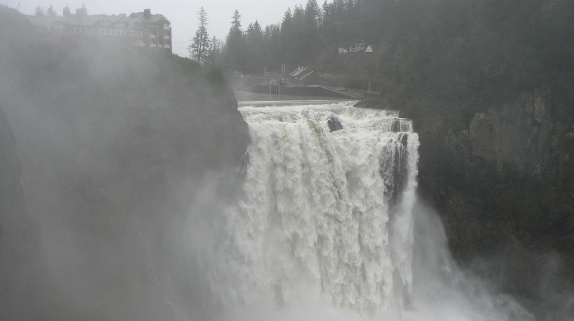 View of famous Snoqualmie Falls near Seattle in gray weather with heavy flow over the falls best places to experience stormy weather around Seattle