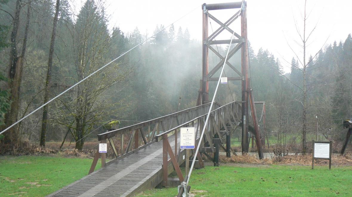 Tolt-McDonald Park suspension bridge in the eastside suburbs of Seattle show in foggy conditions best places to see stormy weather with kids