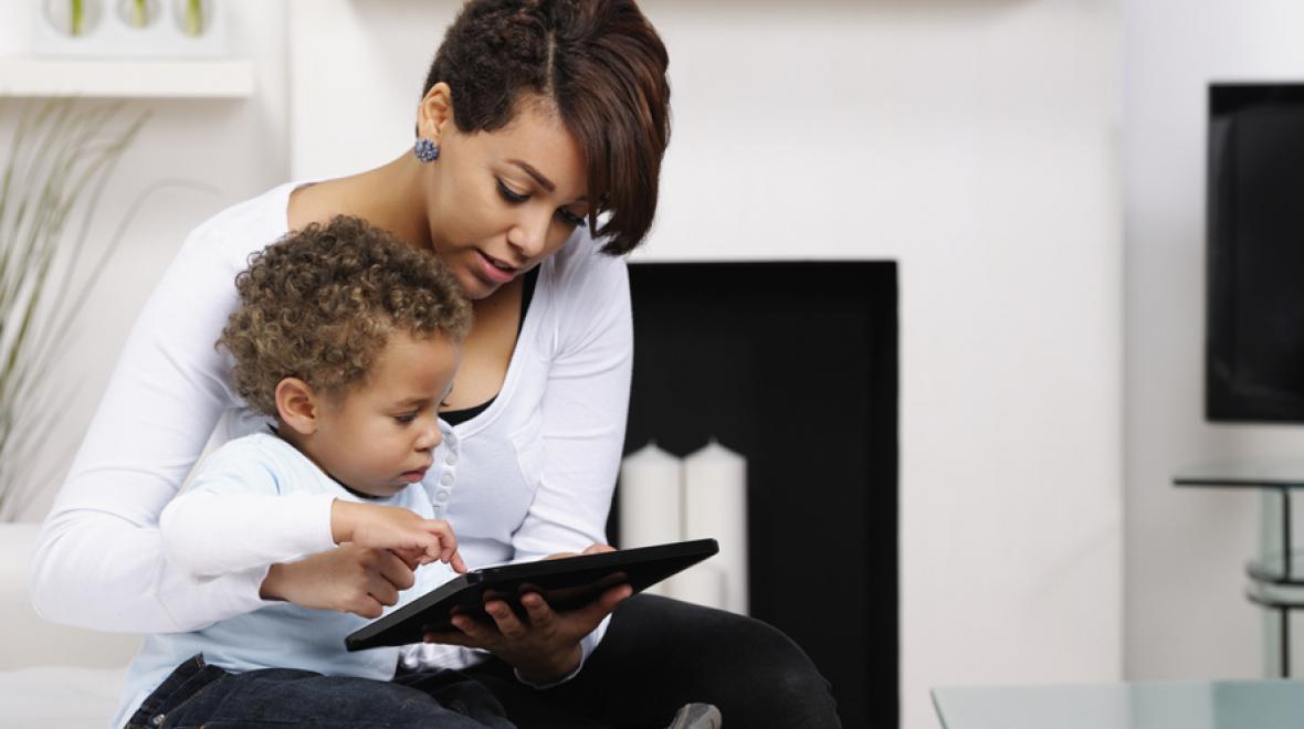 mom and tot watching an ipad together