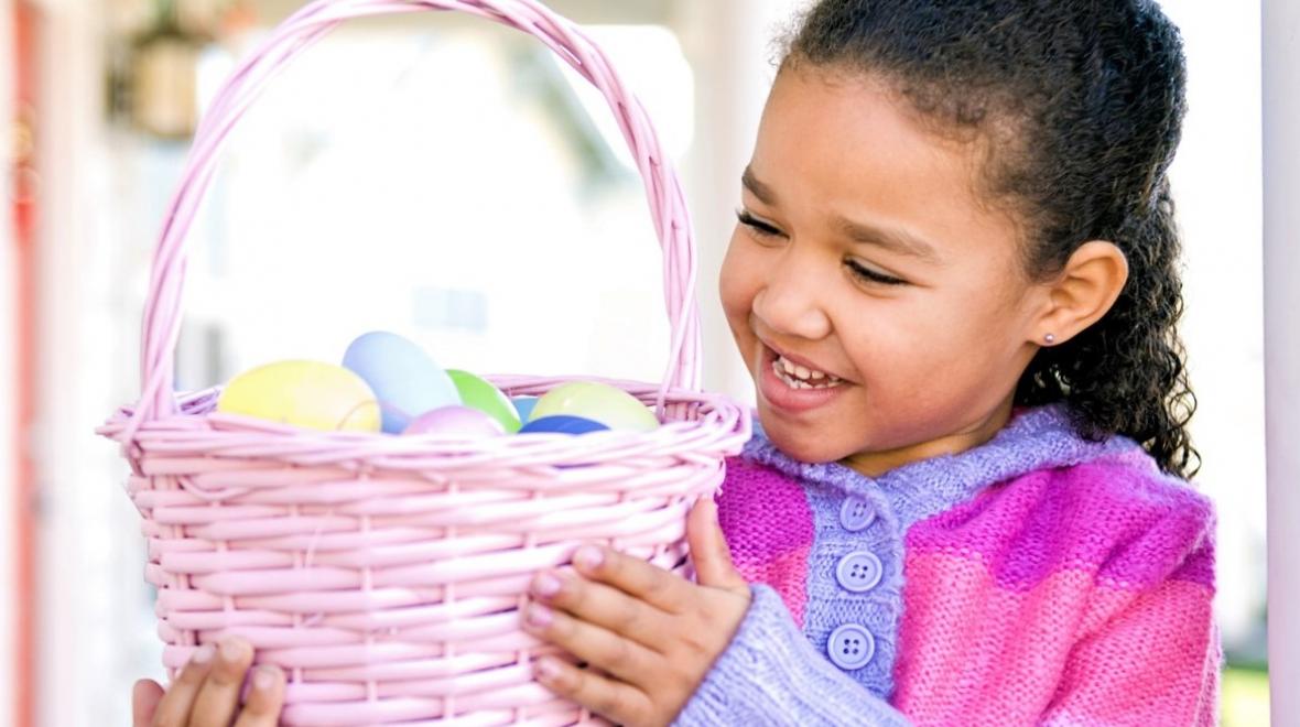 Smiling girl holding up her Easter basket best Easter events Seattle kids and families in 2021