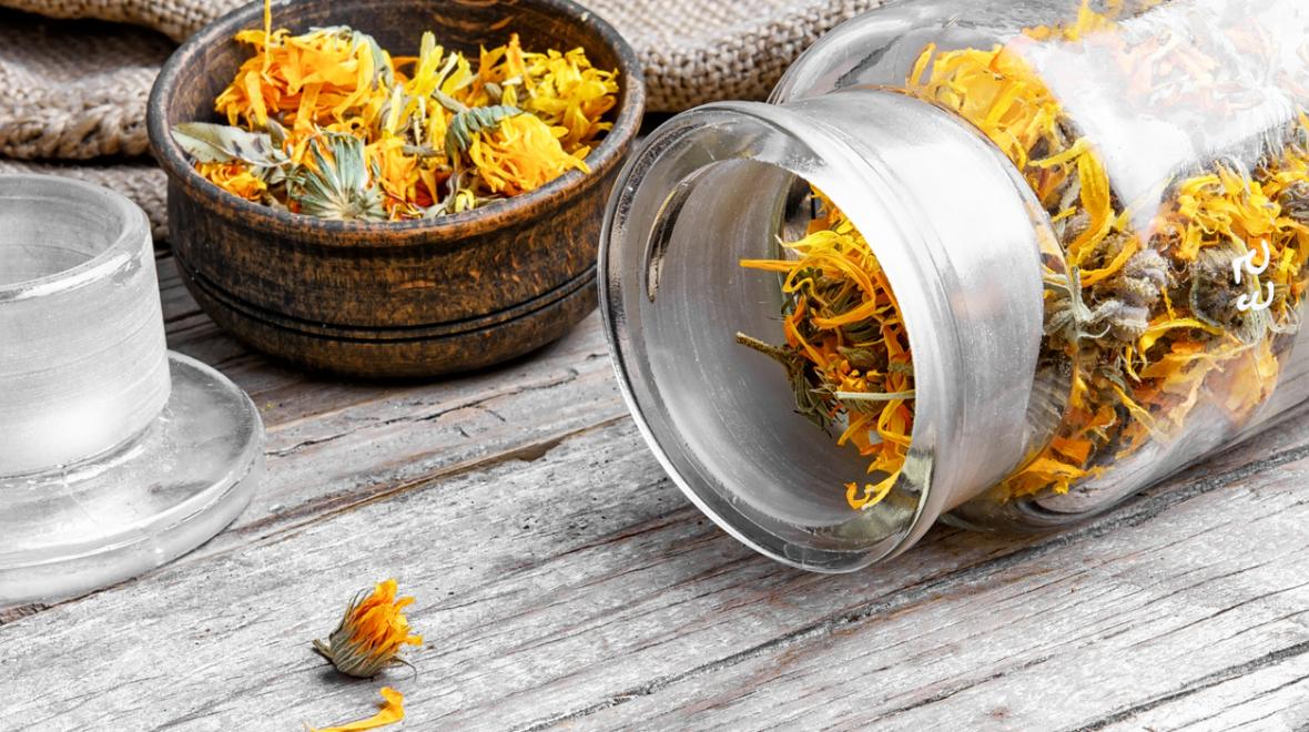 A bottle filled with dried calendula blossoms