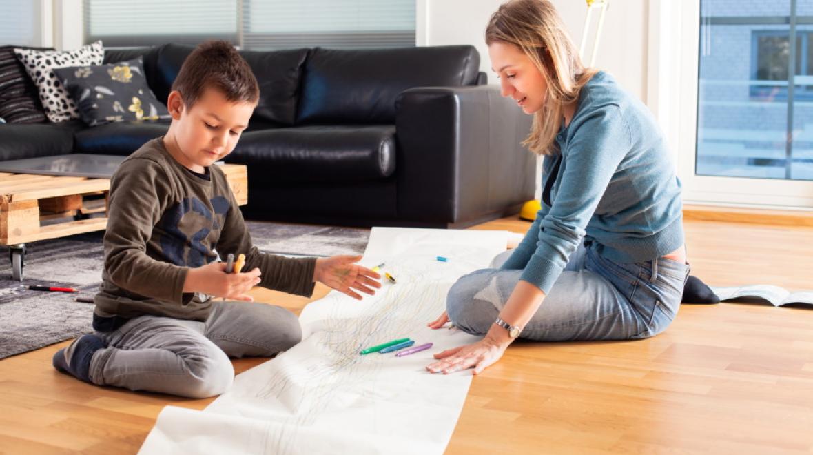 Mom-and-kid-working-with-large-roll-of-paper