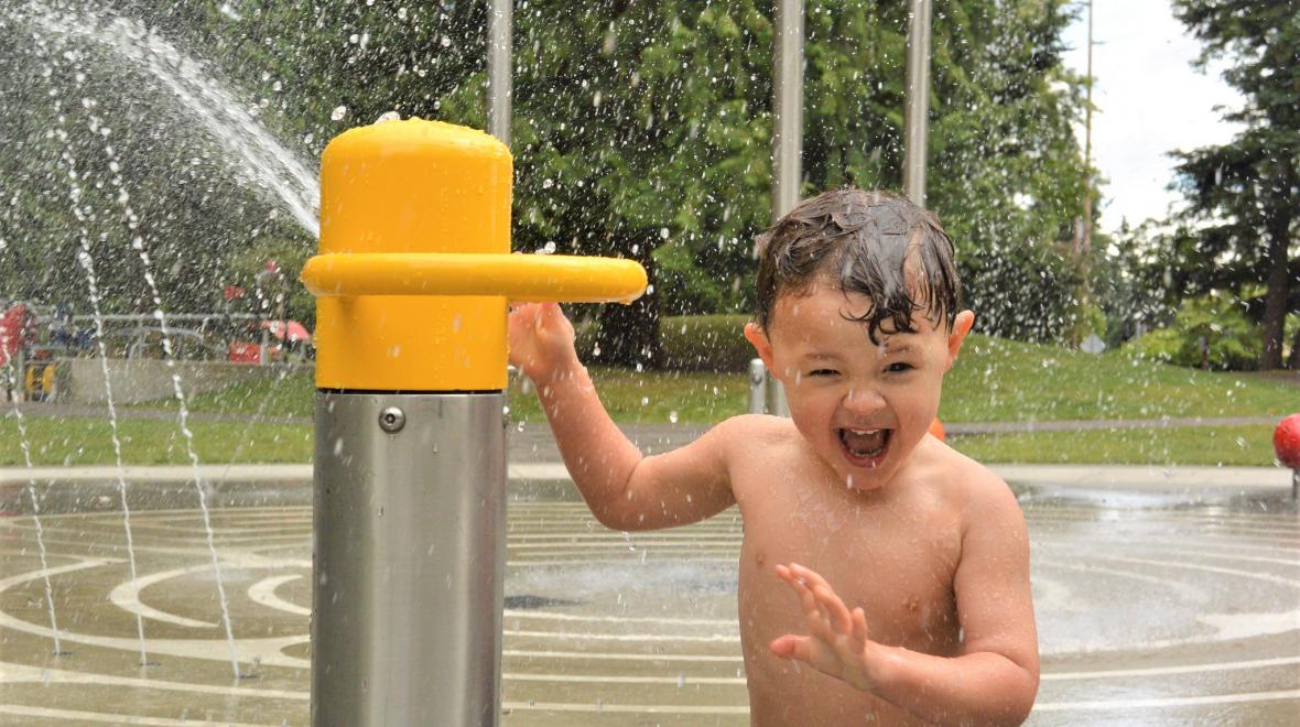 Splashing at a spray fountain to stay cool during a Seattle heat wave