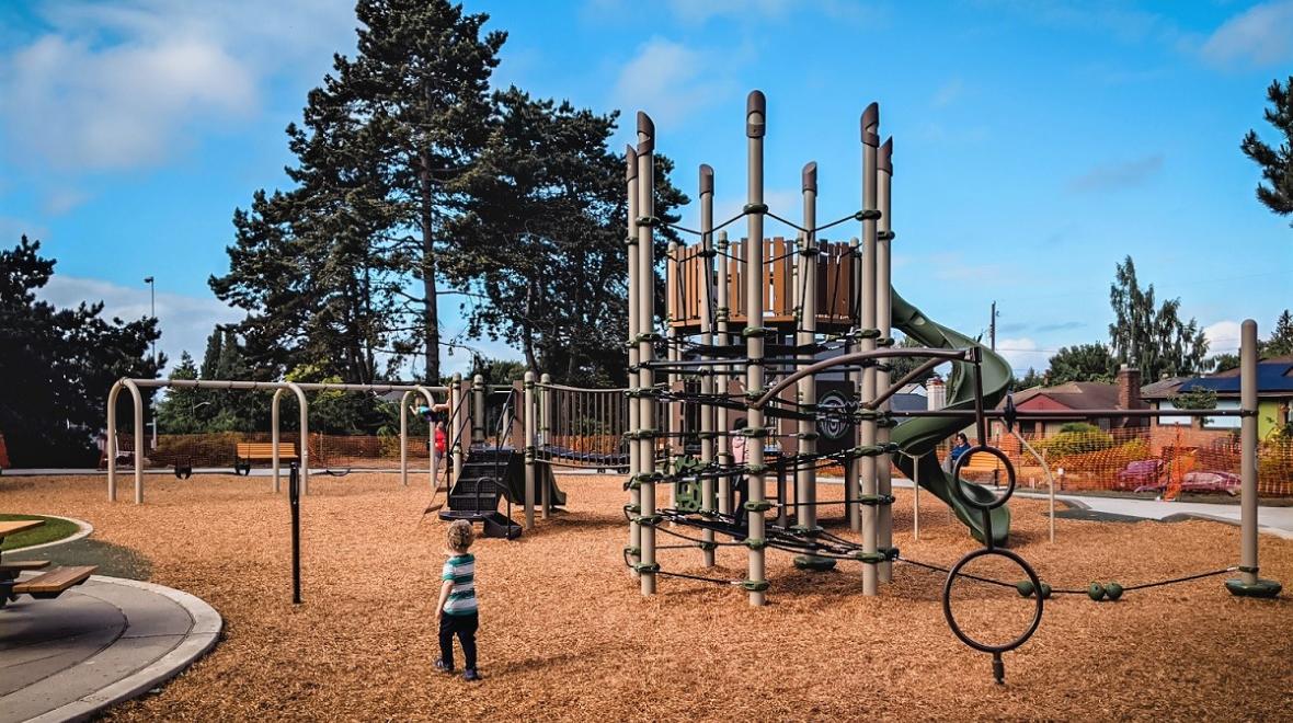 View of children playing at new Loyal Heights Playfield playground opened June 2021