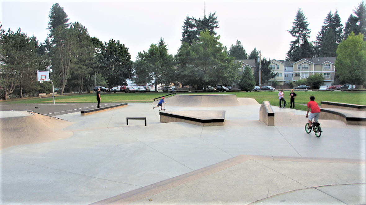 Kids scooting and skateboarding at Virgil Flaim skate spot Lake City neighborhood best Seattle skate parks for kids