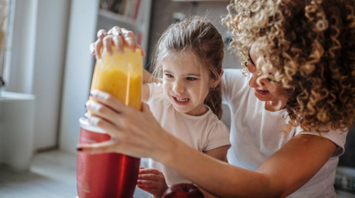 kid-making-smoothie-with-mom