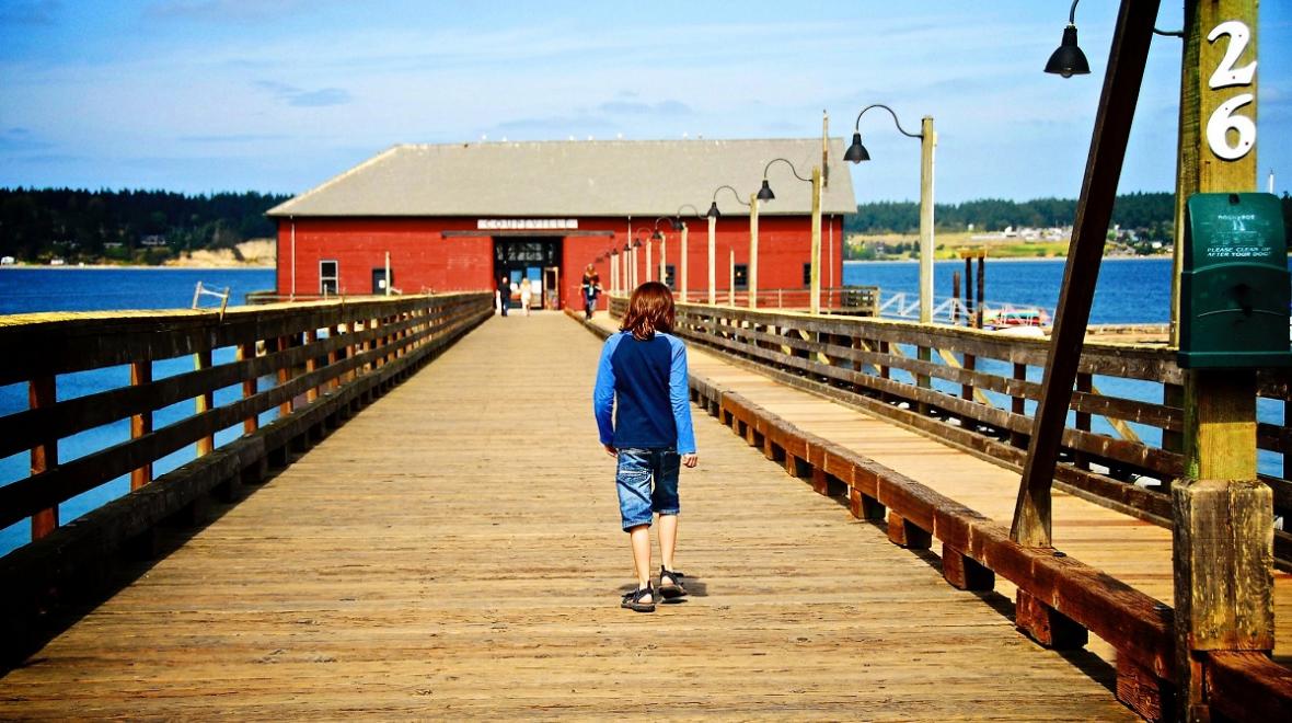 Child walking on the wharf in Coupeville Whidbey Island, among best places to visit with kids