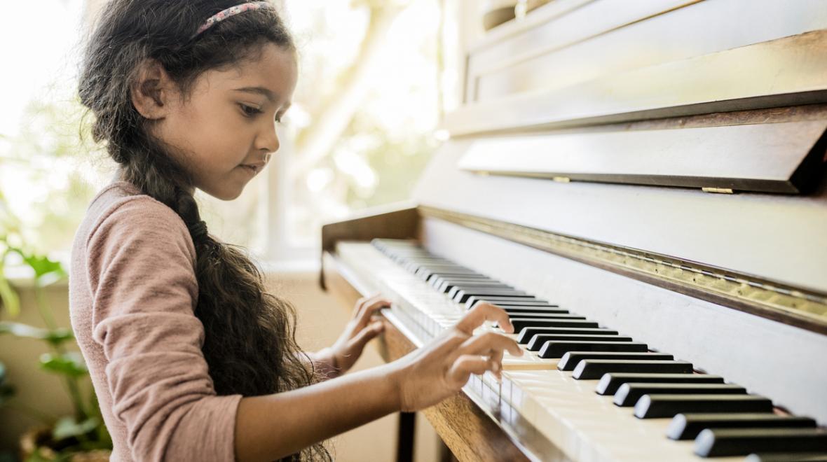 girl playing piano at home