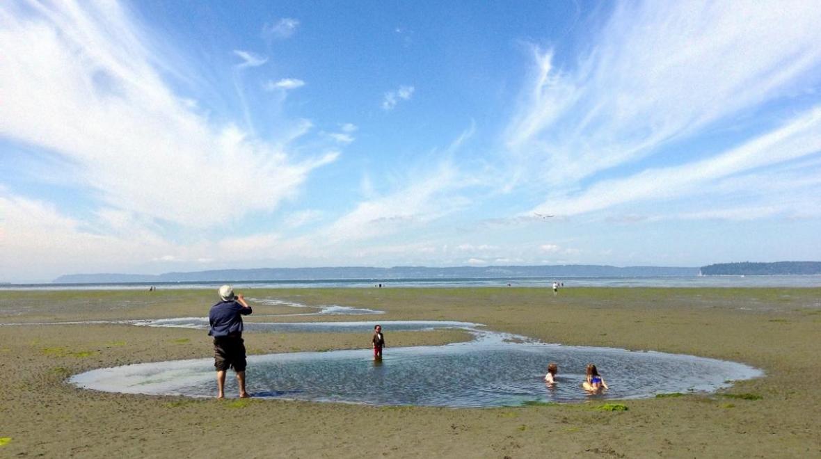 kids playing on the wide expanse of jetty island's beach
