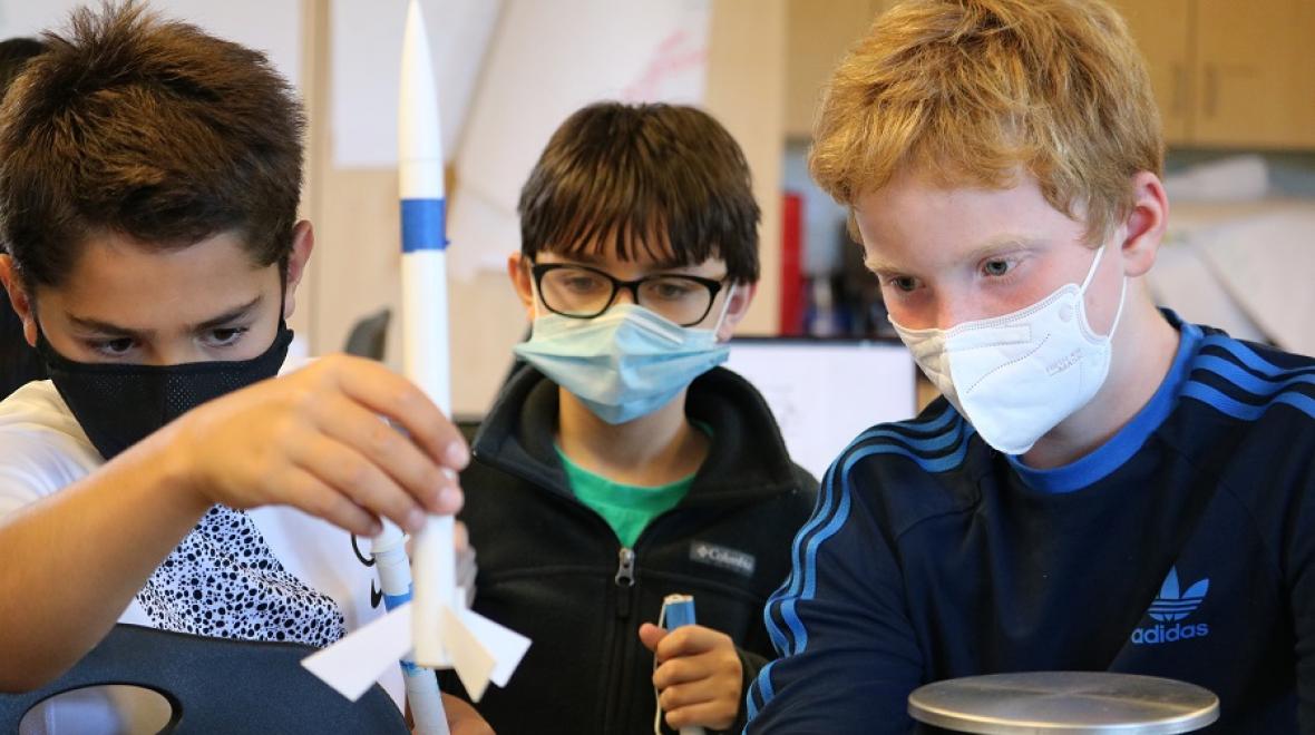 Three sixth-grade students from University Prep  work together on a science experiment