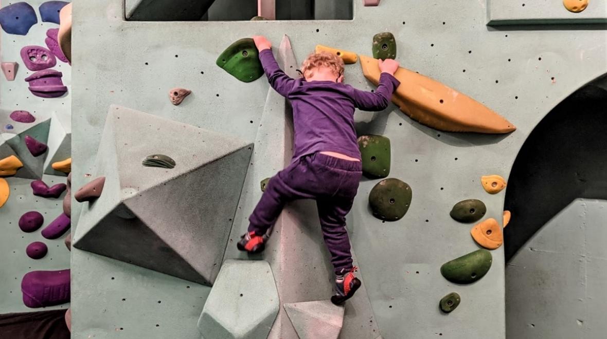 kid on a bouldering rock climbing wall at Seattle Bouldering Project a tot-sized outing for when you need to get home in time for school pick up