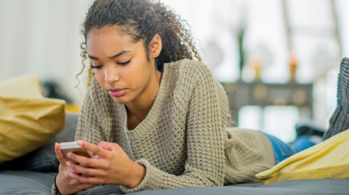 Teen-girl-looking-at-cell-phone