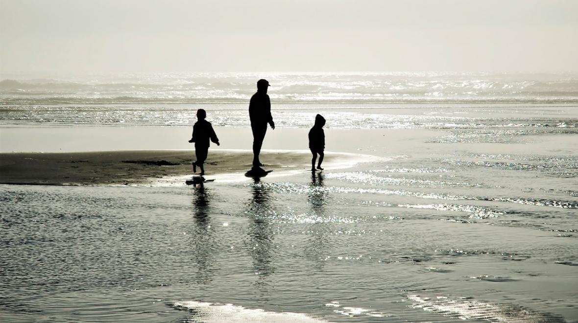 Kids playing in the small waves at Long Beach Washington best family getaways from seattle for winter spring 2021-2022