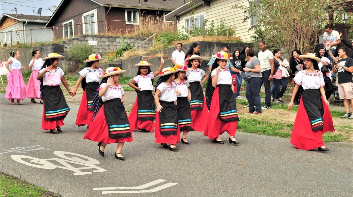 Girls in Mexican cultural dress march in Seattle's Fiestas Patrias parade in 2015