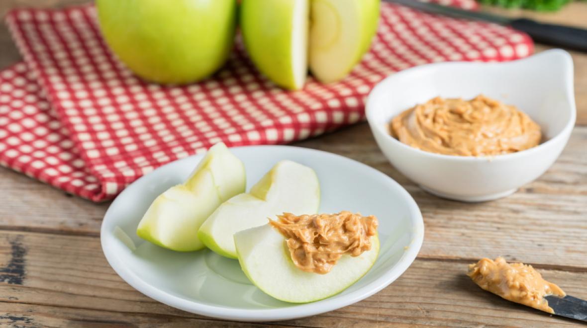A plate of apple slices with peanut butter