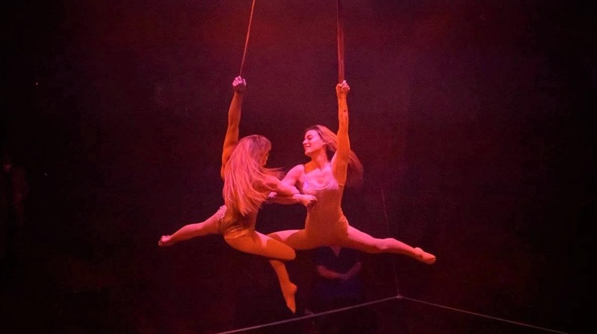 Two performers hang from straps in Emerald City Trapeze Arts' show calle I See Why playing in Seattle