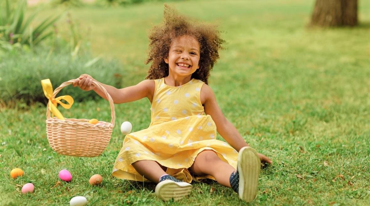 Smiling girl holding up her Easter basket best Easter events Seattle kids and families in 2022