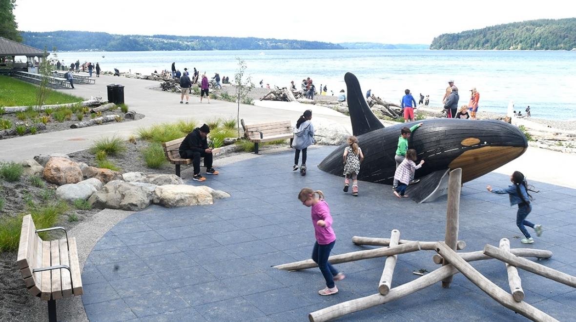 Kids play on the orca whale sculpture at Tacoma's recently reopened Owen Beach in Point Defiance Park