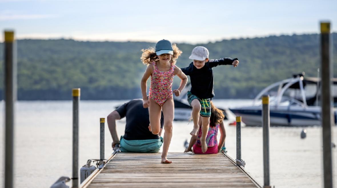 kids-running-on-dock-in-summer