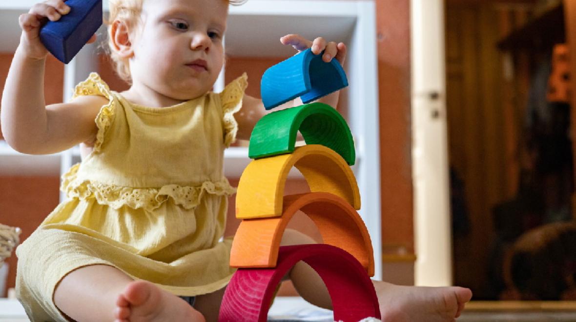 Baby-playing-with-wooden-rainbow-toy