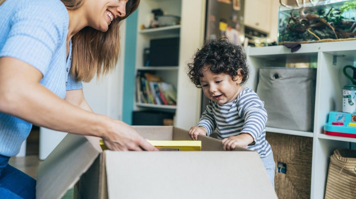 Mom and toddler opening a box