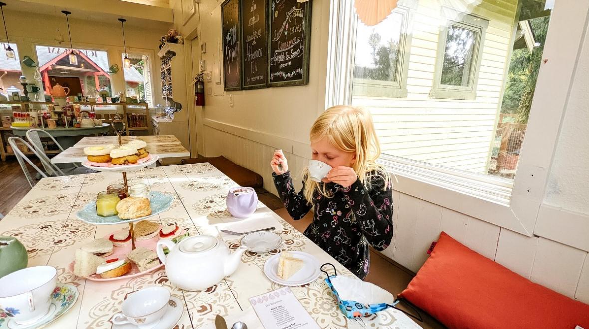 Young girl sipping a cup of tea at the Paisley Parlour 