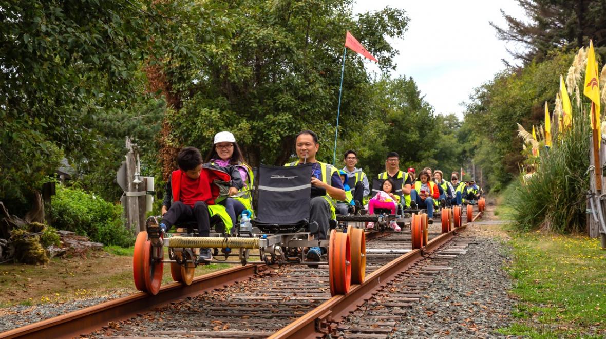Families ride on rail bikes on an excursion from Oregon's Tillamook Coast, fun destination any time of year
