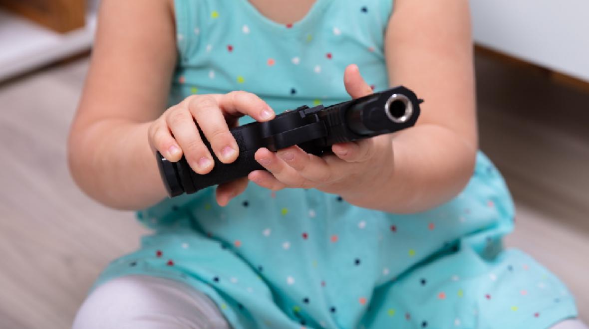 Toddler-holding-a-gun