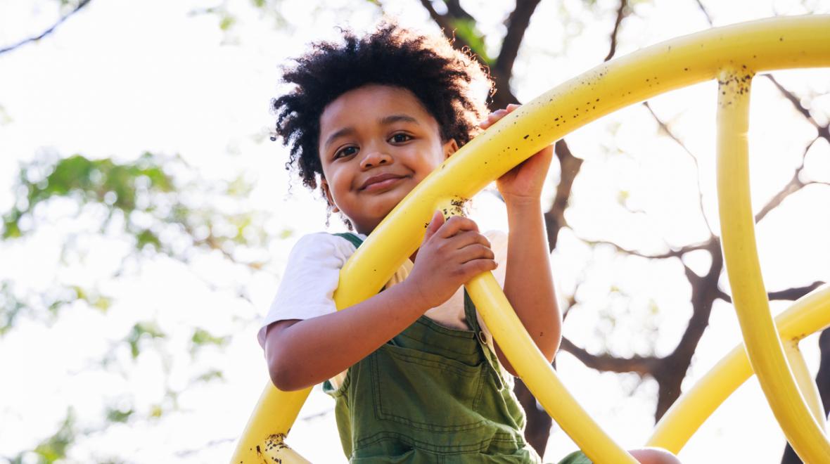 Little boy on a yellow climbing structure 