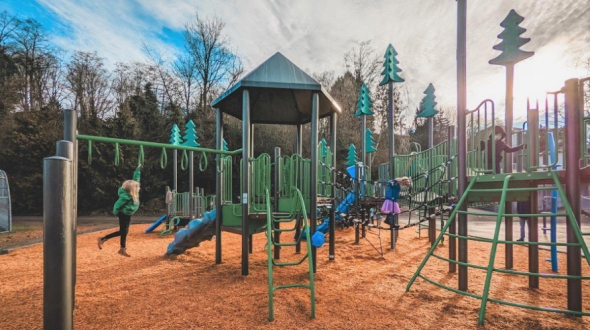 Kids play on the new play structures at Seattle’s renovated Fairmount Playground. 