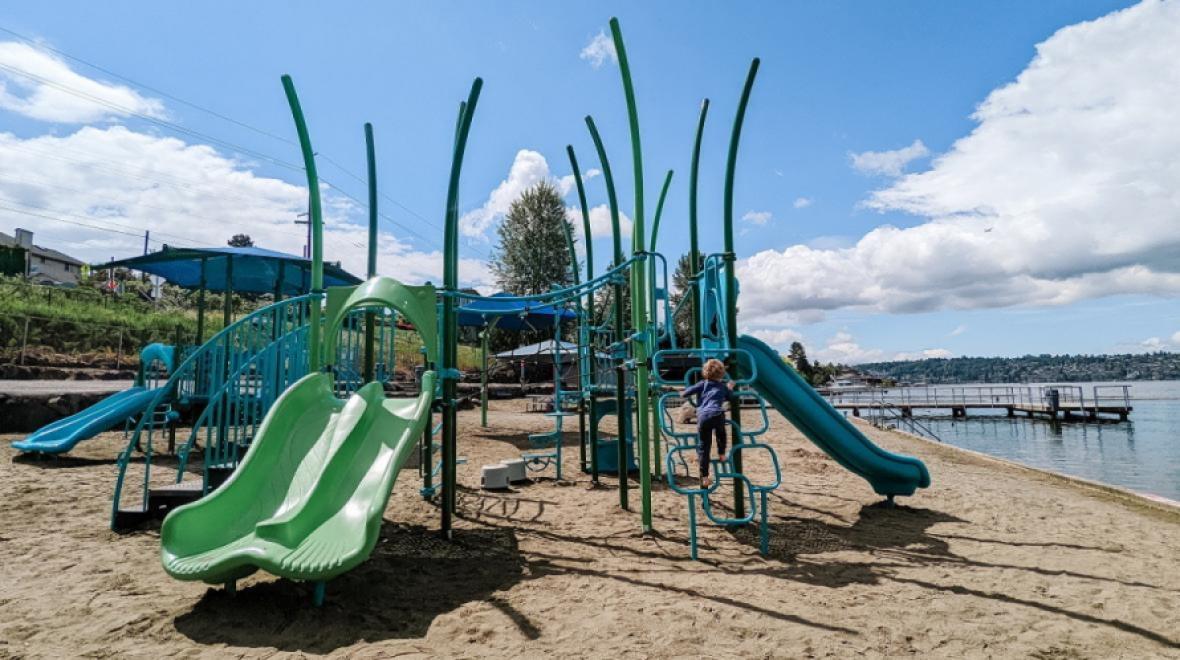 Blue and green playground on the beach at Kennydale Beach Park