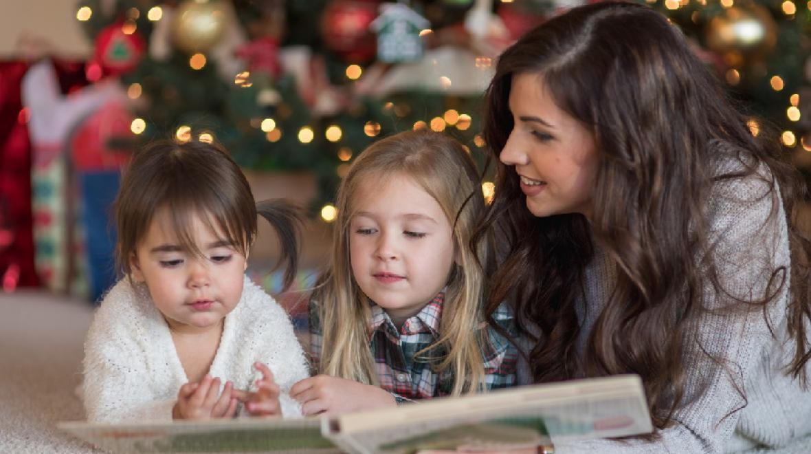 Mom-reading-to-kids-by-Christmas-tree