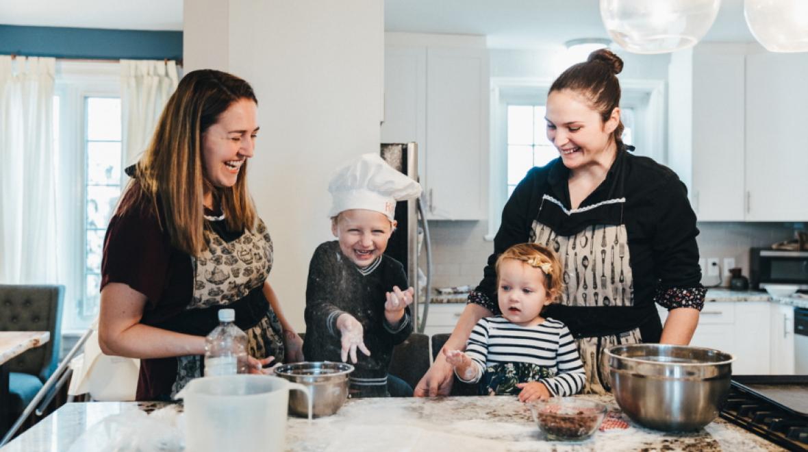Family cooking together with young child making mess with flour