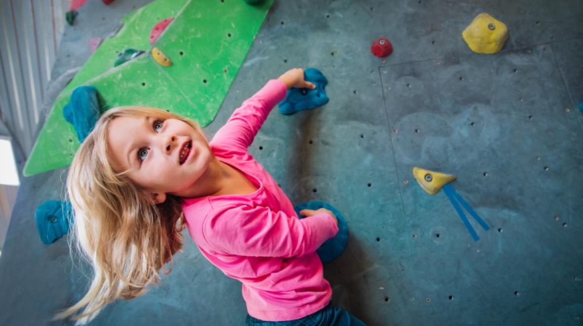 Young girl on a rock climbing wall