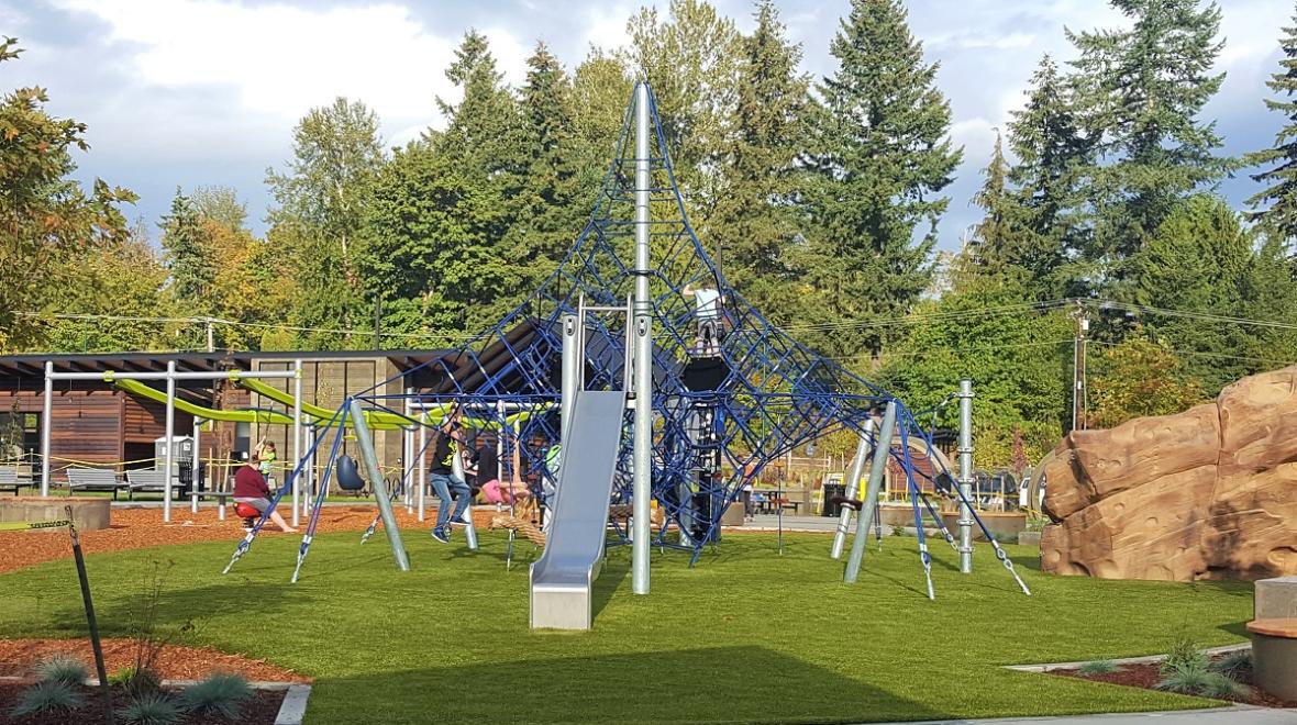 Kids play on a high rope climber at the recently updated playground at Covington Community Park best Seattle weekend activities for kids and families