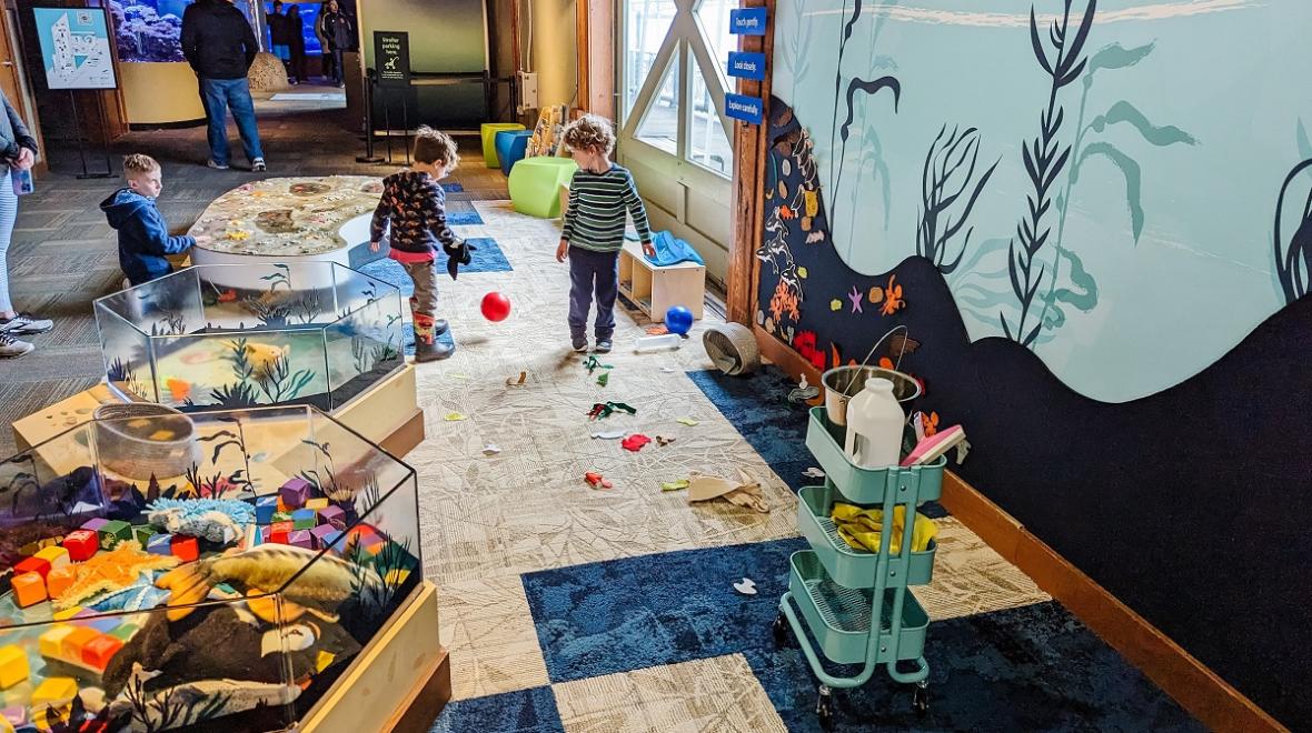 Two preschool-age children play in the Caring Cove indoor play area at the Seattle Aquarium. Caring Cove recently underwent a refresh.
