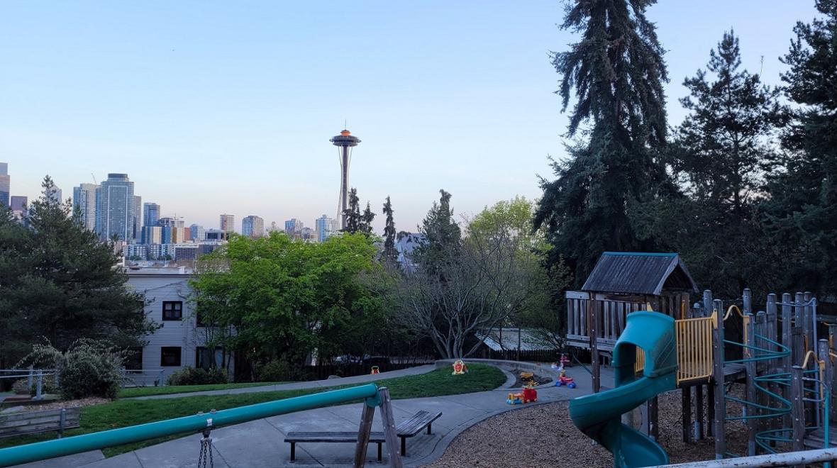 View of the Space Needle with the top painted orange from tiny Ward Springs Park on the south slope of Queen Anne Hill