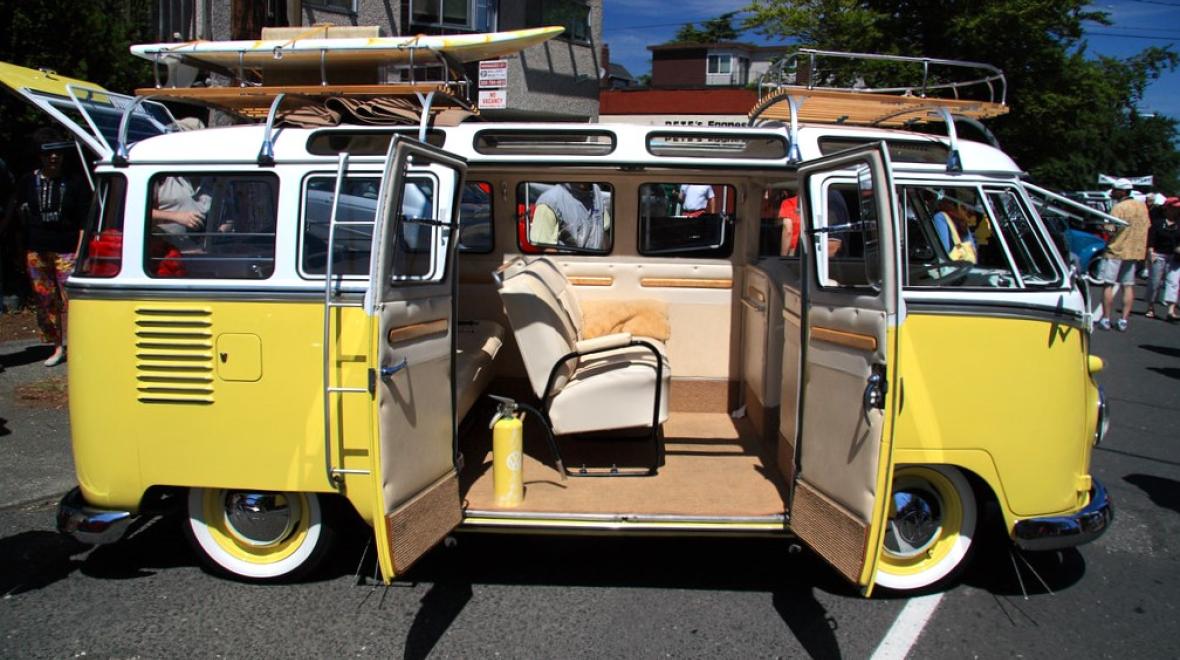 A yellow volkswagen bus is on display at the popular annual Greenwood Car Show among family activities in Seattle for summer