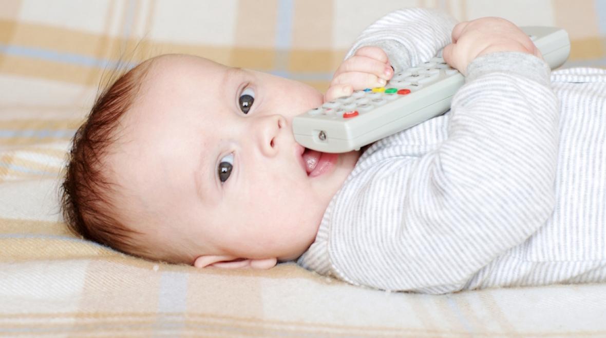 Baby holding a remote control 