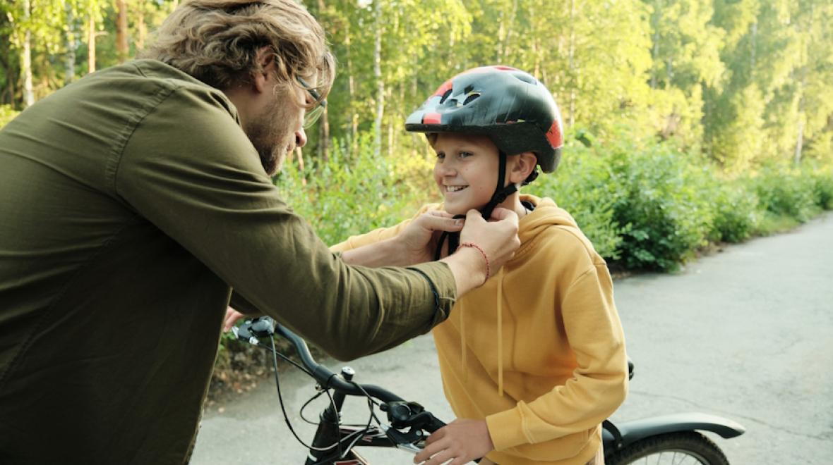 Young boy on a bike with a helmet 