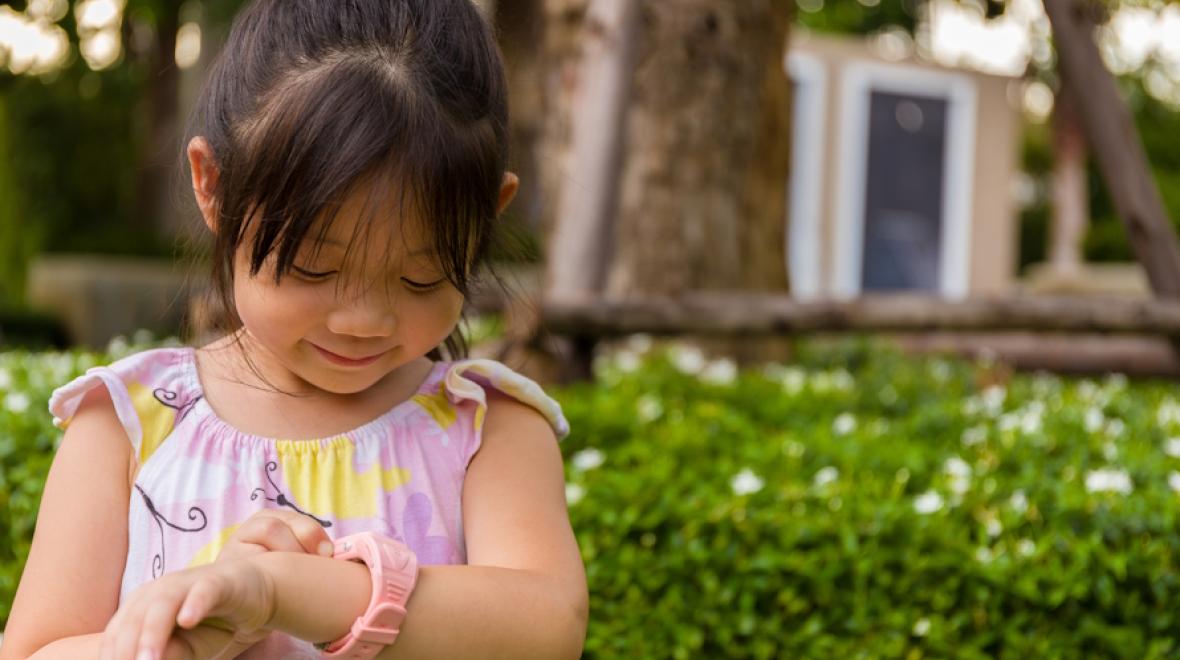 Young girl looking at her smartwatch