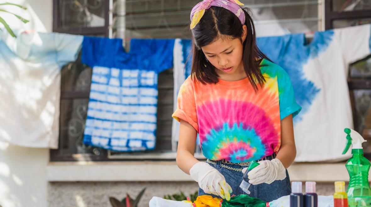 Girl making a tie dye shirt as a birthday party craft idea