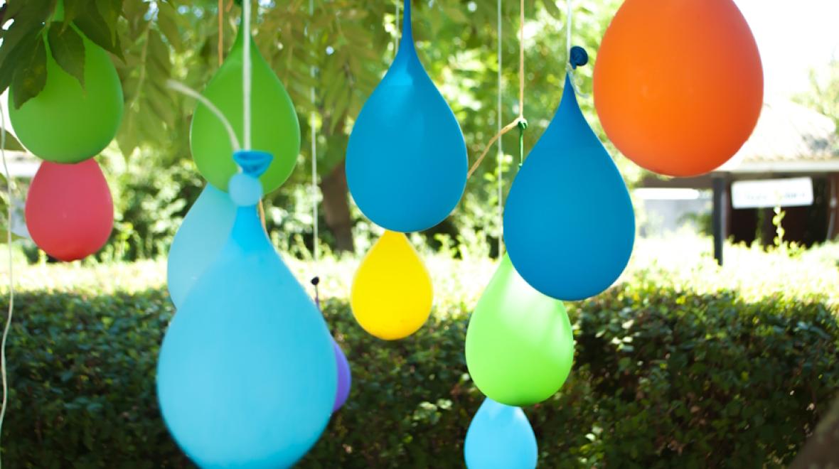 Water balloons hanging from a tree is an easy DIY Water play idea for kids