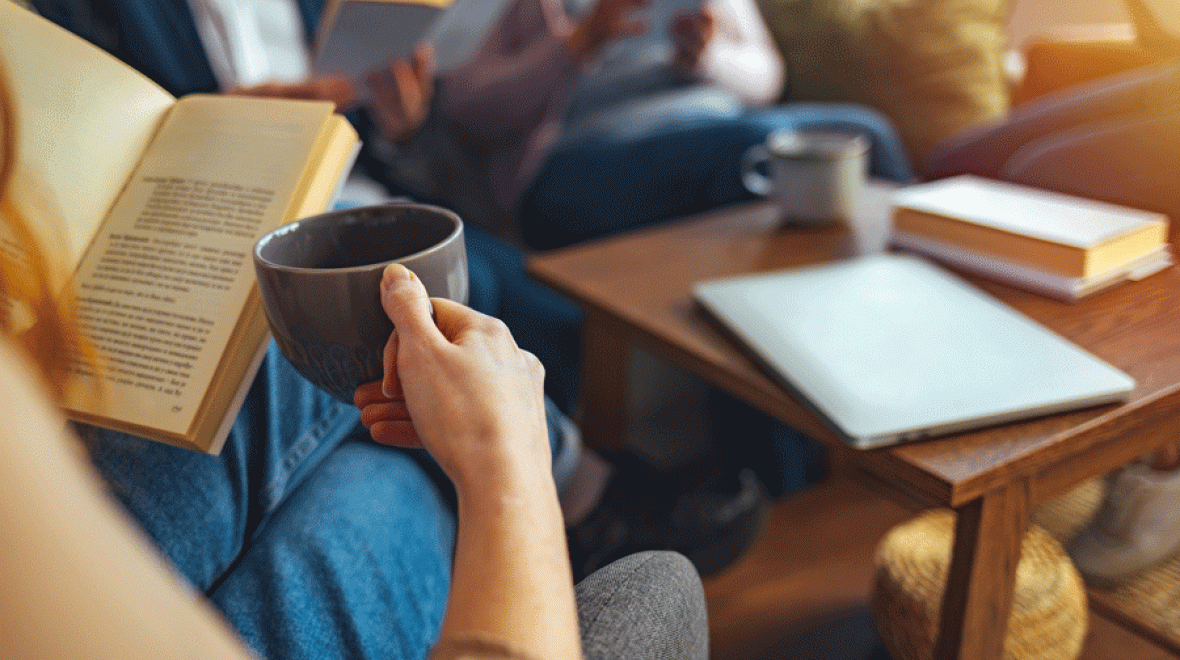 how to start a book club includes coffee and an open book around a table